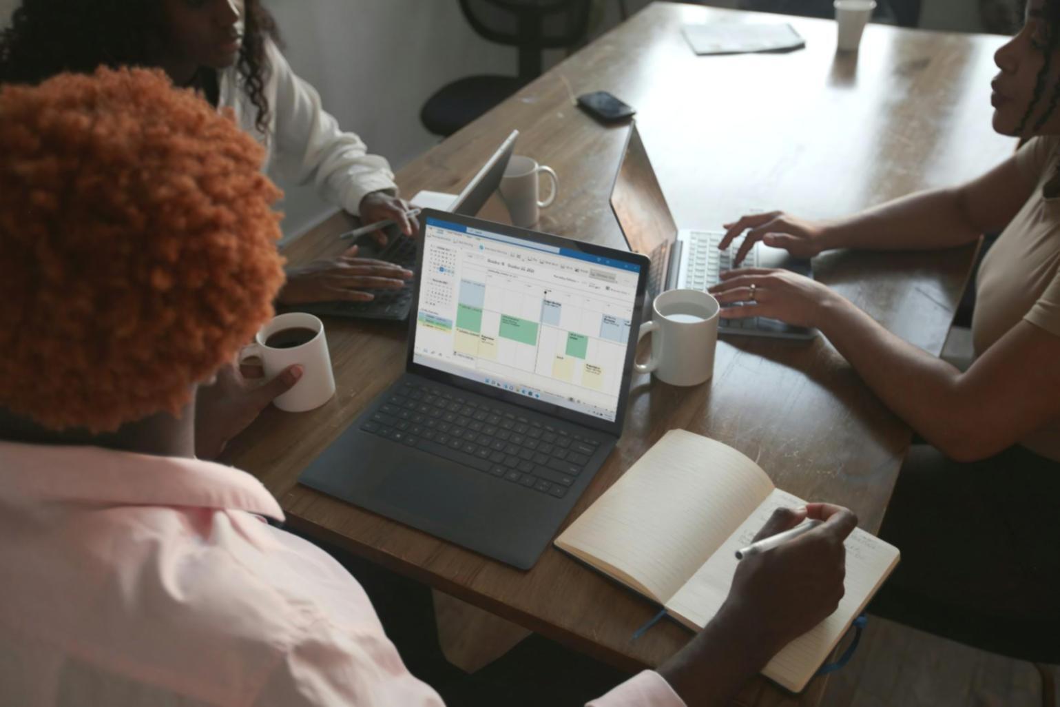 Person reviewing financial documents and planning materials at desk